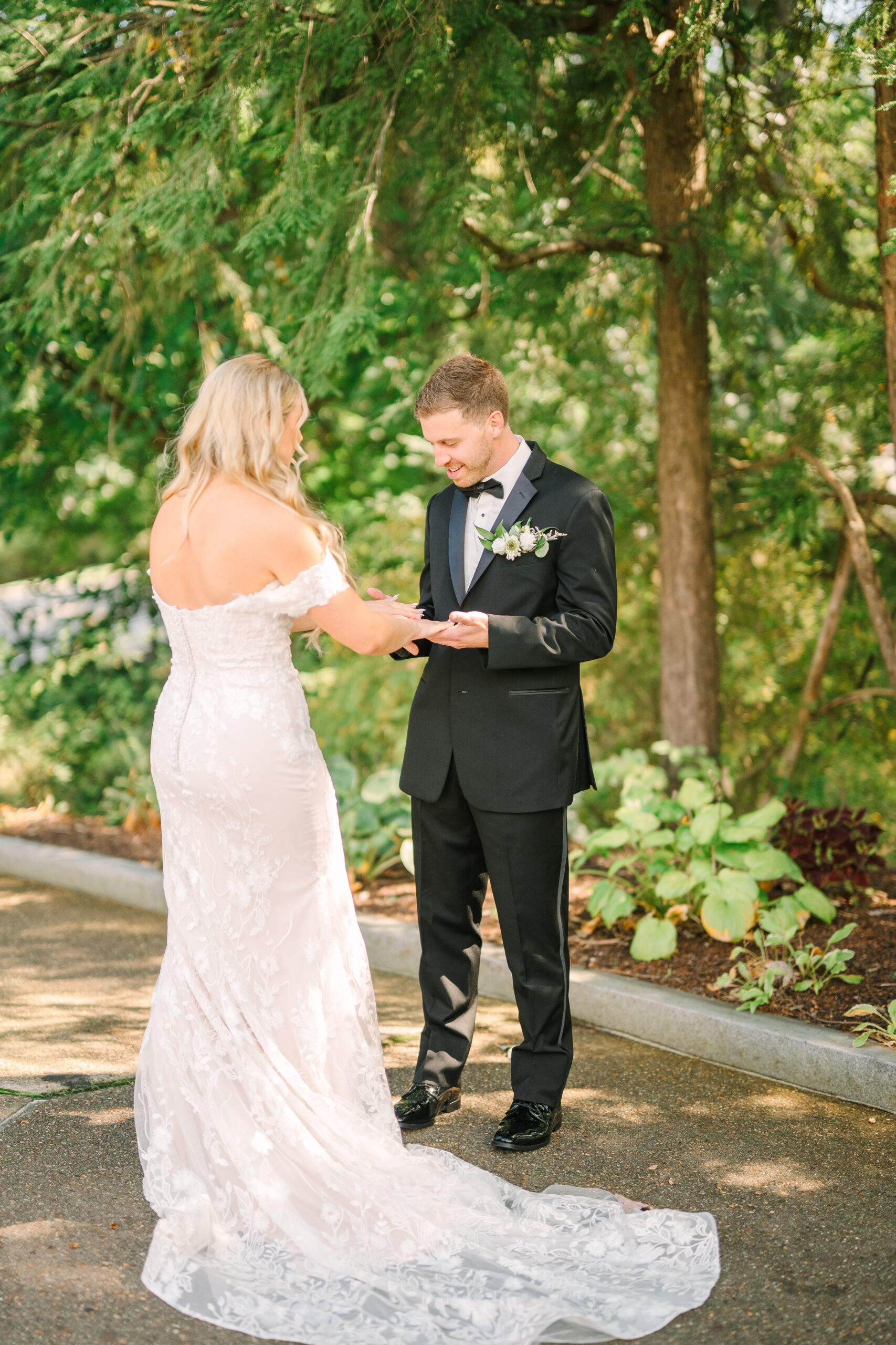 Candid joy captured as couple embraces laughing during their first look, their genuine emotions on full display in this private moment