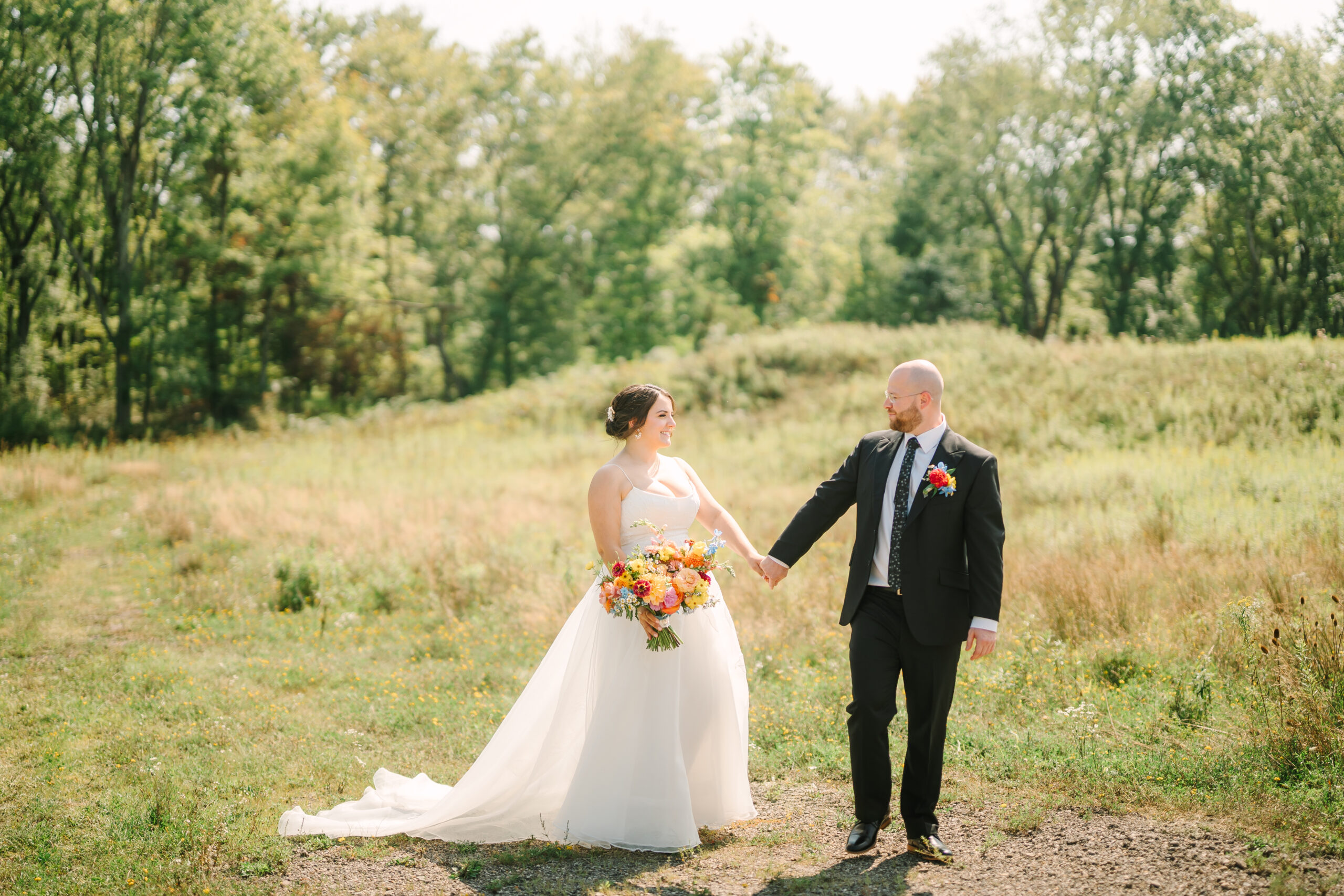 A couple walks through the fields neighboring Twelve Oaks Mansion