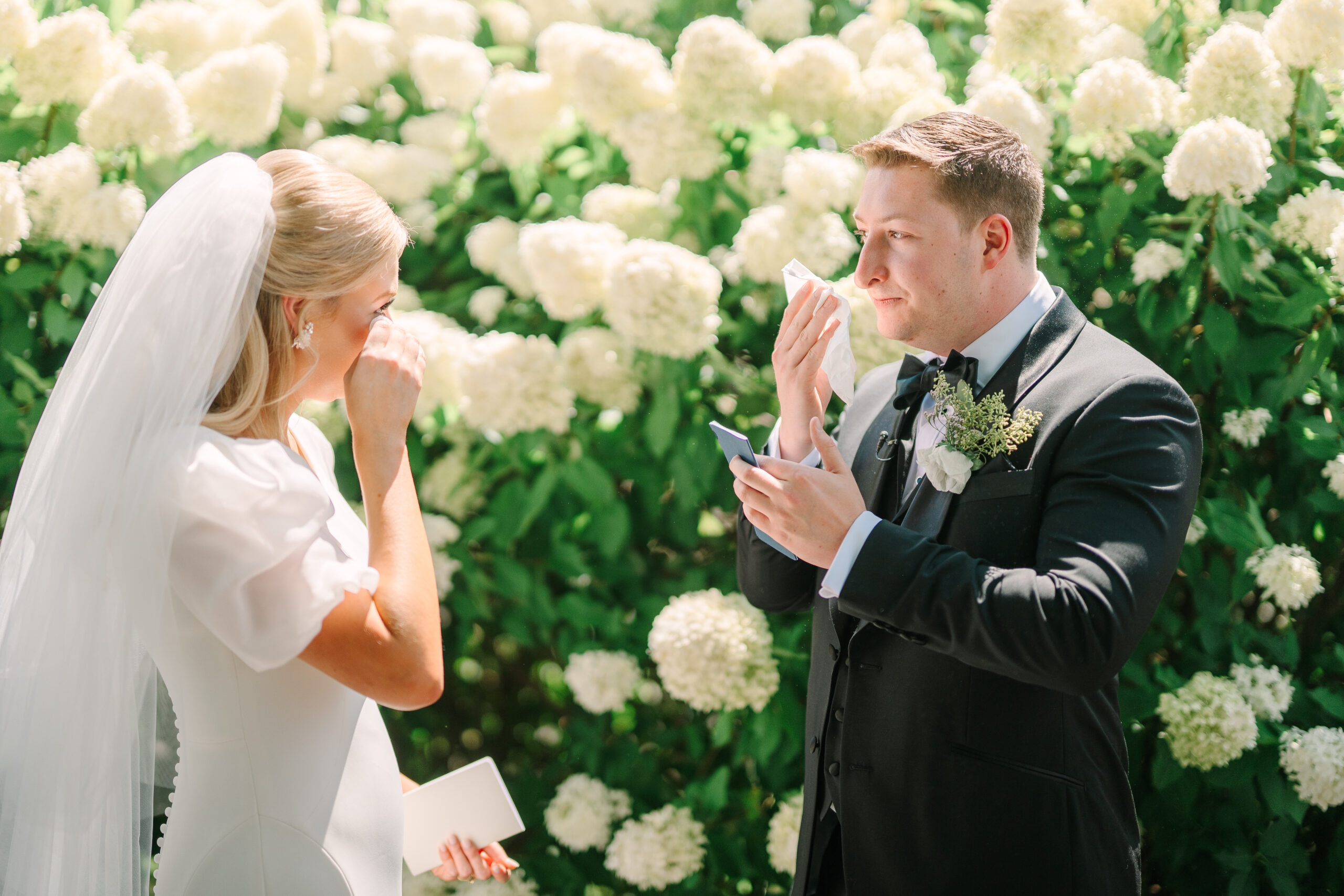 Intimate candid shot of a couple drying their tears after sharing their private vows