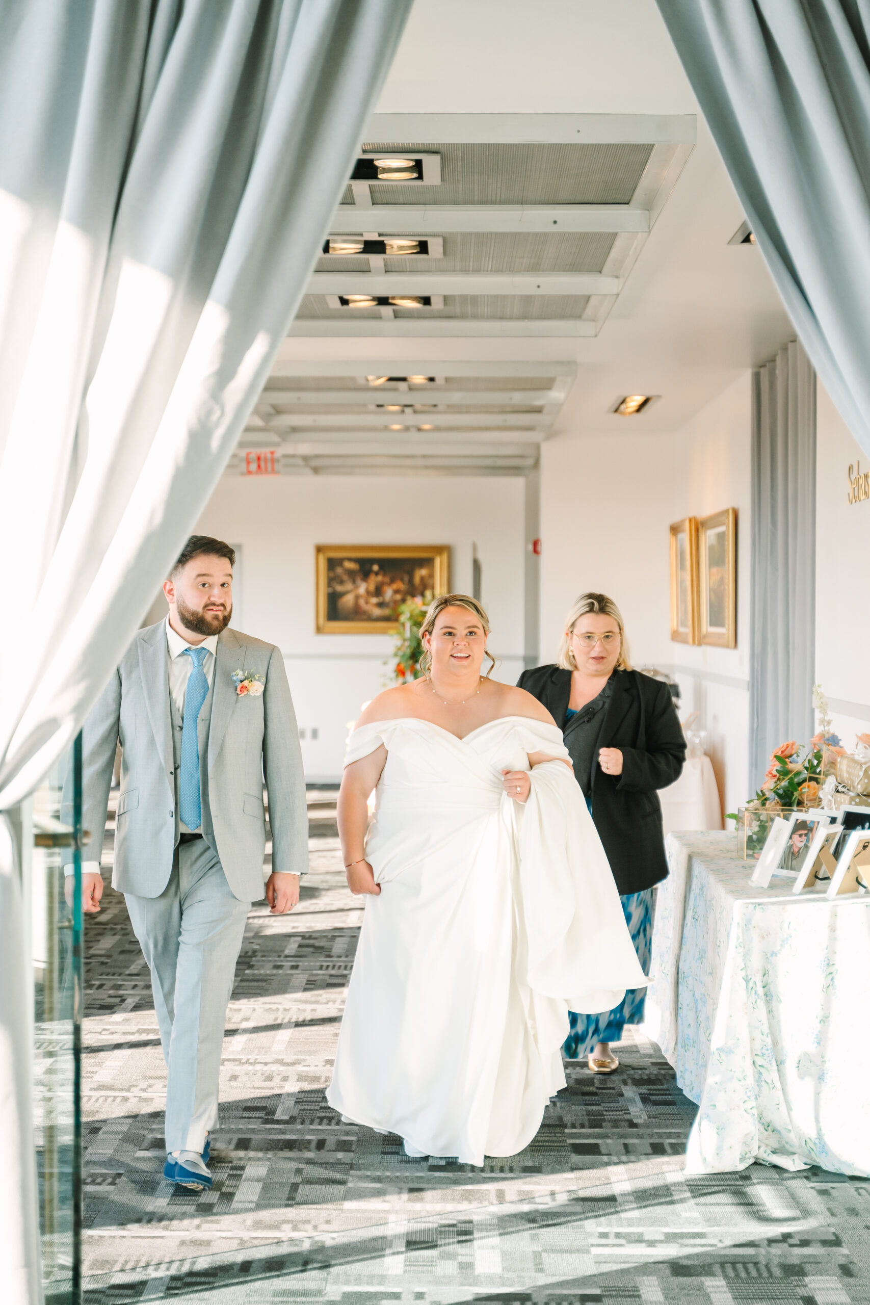 Tori of LaEventor escorting in the couple to see their reception space for the first time