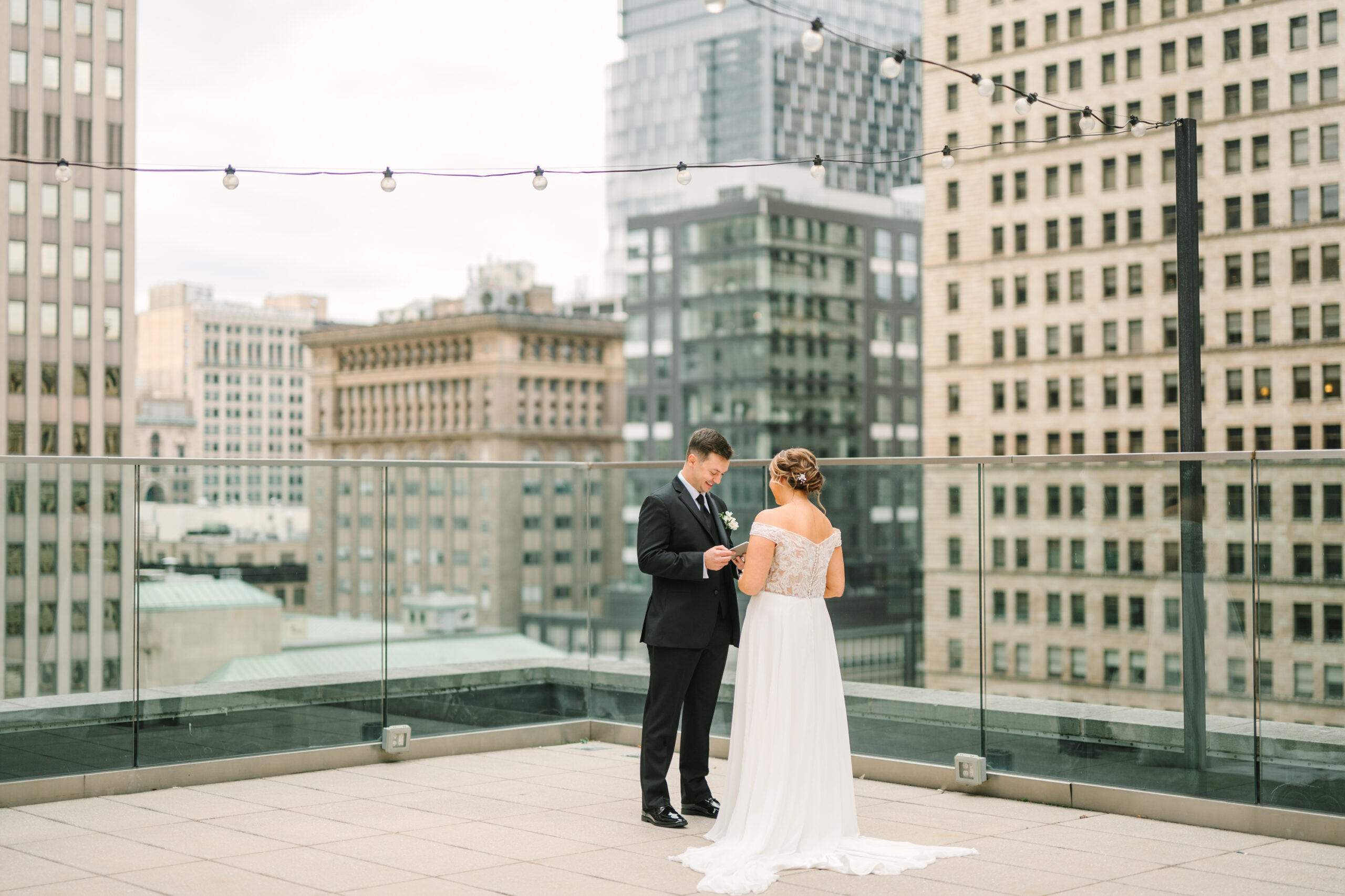 Wedding couple on the rooftop of Hotel Monaco in Pittsburgh with city skyline backdrop