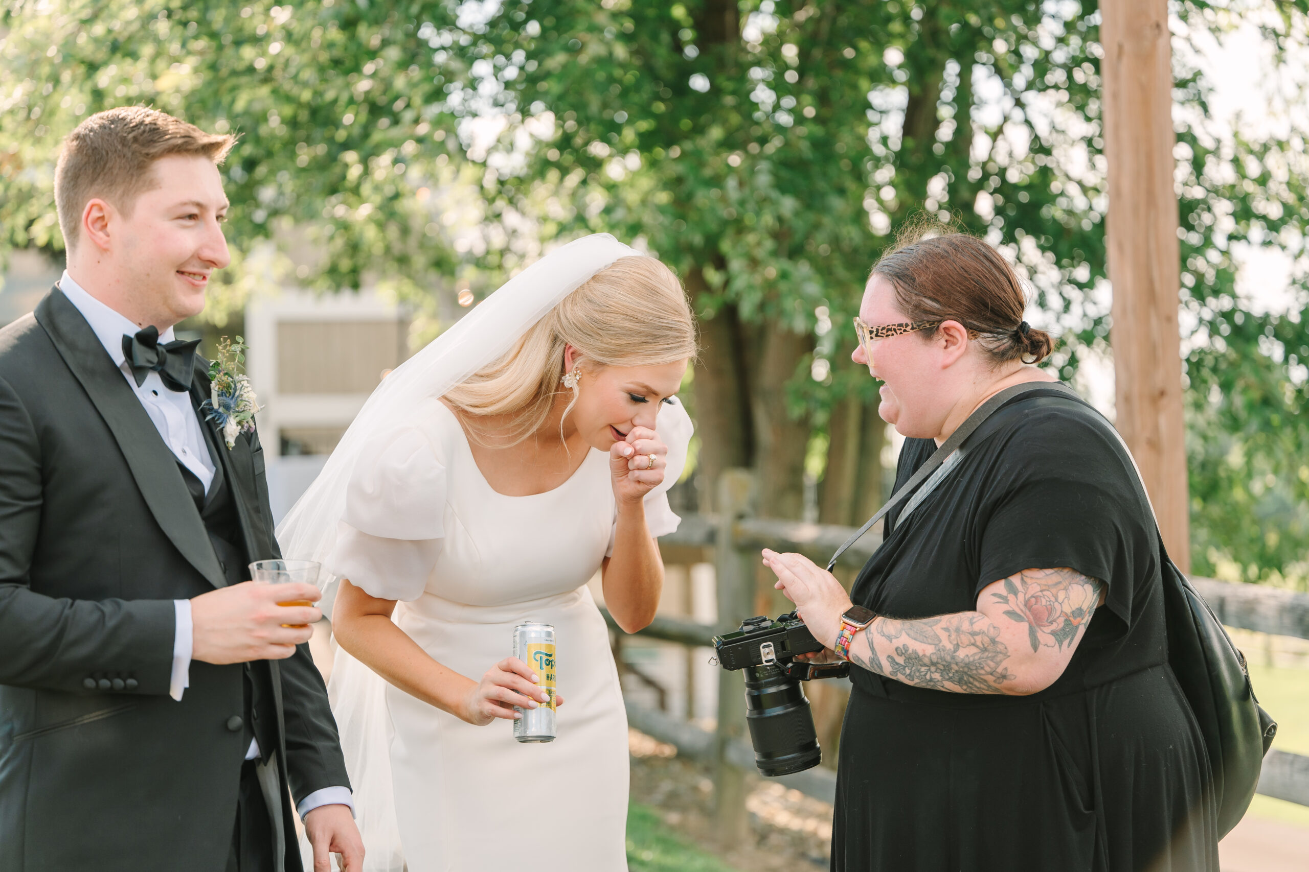 Dawn gives a newlywed couple a sneak peek of their portraits on the back of her camera during their wedding day